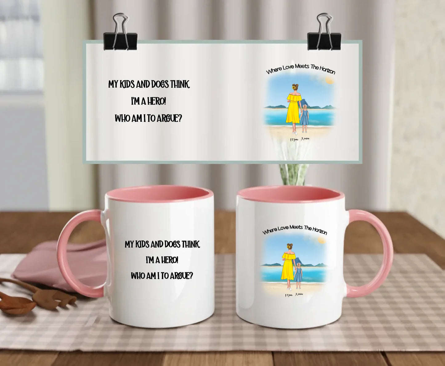 Pink-handled mug with custom beach scene and quote “My kids and dogs think I’m a hero – who am I to argue?” – illustrated mum and child with optional pets – perfect Mother’s Day gift