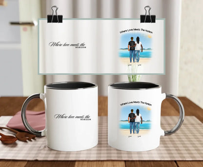 Black-handled ceramic LGBTQ+ mug with custom beach design of two men and “Where love meets the horizon” message – romantic personalised gift for gay couples