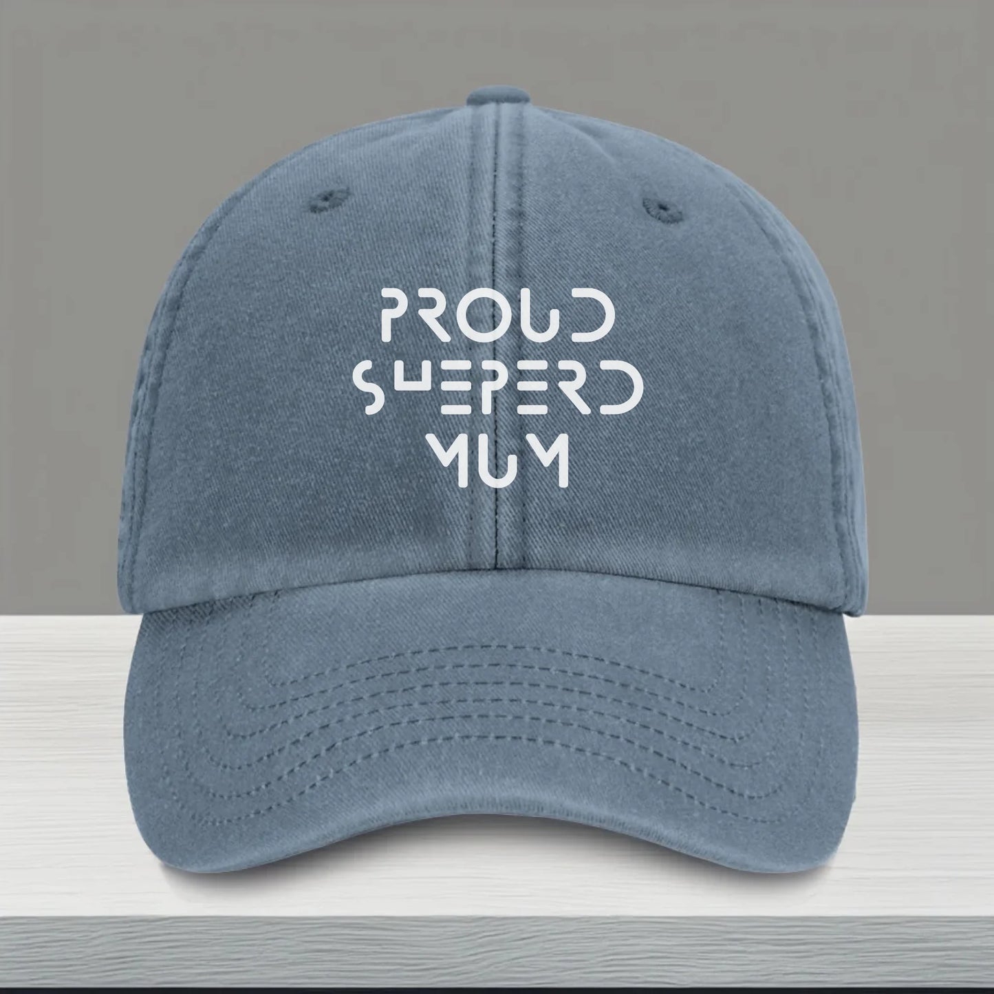 Blue vintage-style personalised cap with white embroidery on the front. Customisable with any dog-related text or name — a perfect everyday accessory for dog mums, dads, or pet lovers.