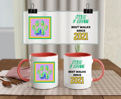 Red-handled ceramic mug with custom names and colourful paw print scene featuring a dog walker, plus bold “Best walks since 2021” message – gift for pet lovers