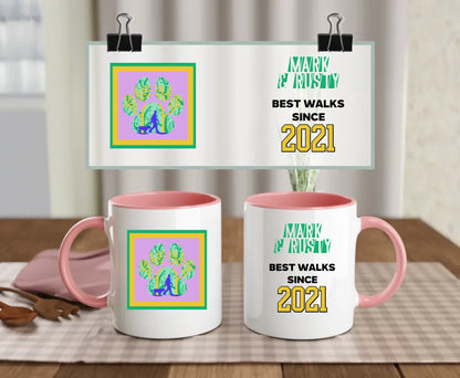 Personalised ceramic mug with pink handle and interior, showing retro “Best walks since 2021” text with colourful paw print scene and custom names – unique gift for dog parents or walking buddies