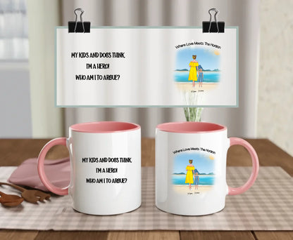 Pink-handled mug with custom beach scene and quote “My kids and dogs think I’m a hero – who am I to argue?” – illustrated mum and child with optional pets – perfect Mother’s Day gift